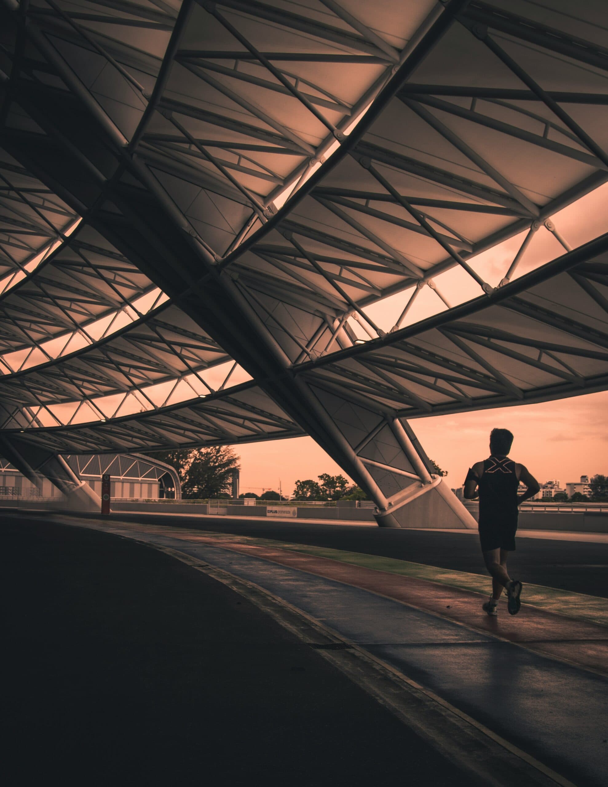 man jogging along kallang stadium