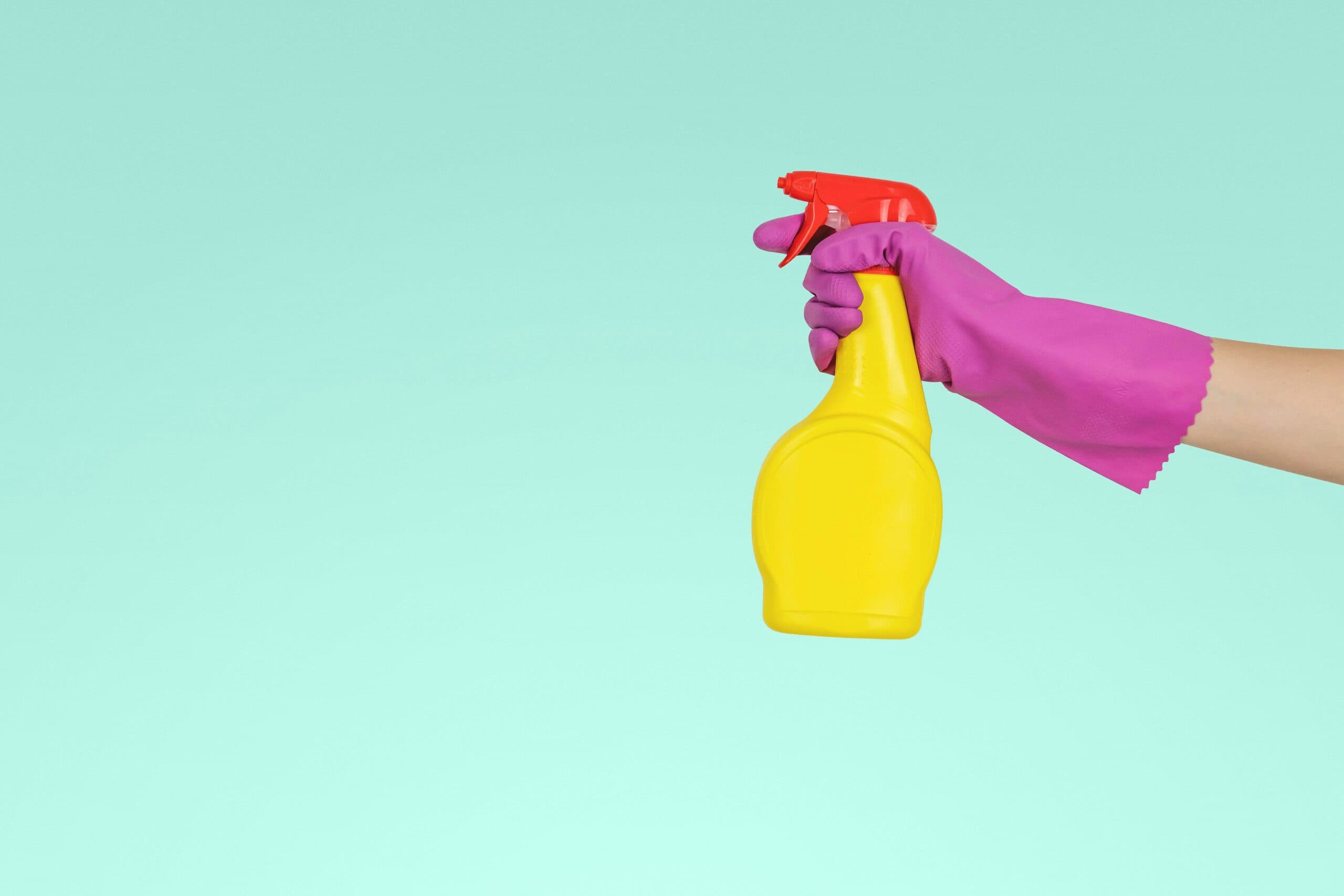 image of a cleaner holding a spray bottle