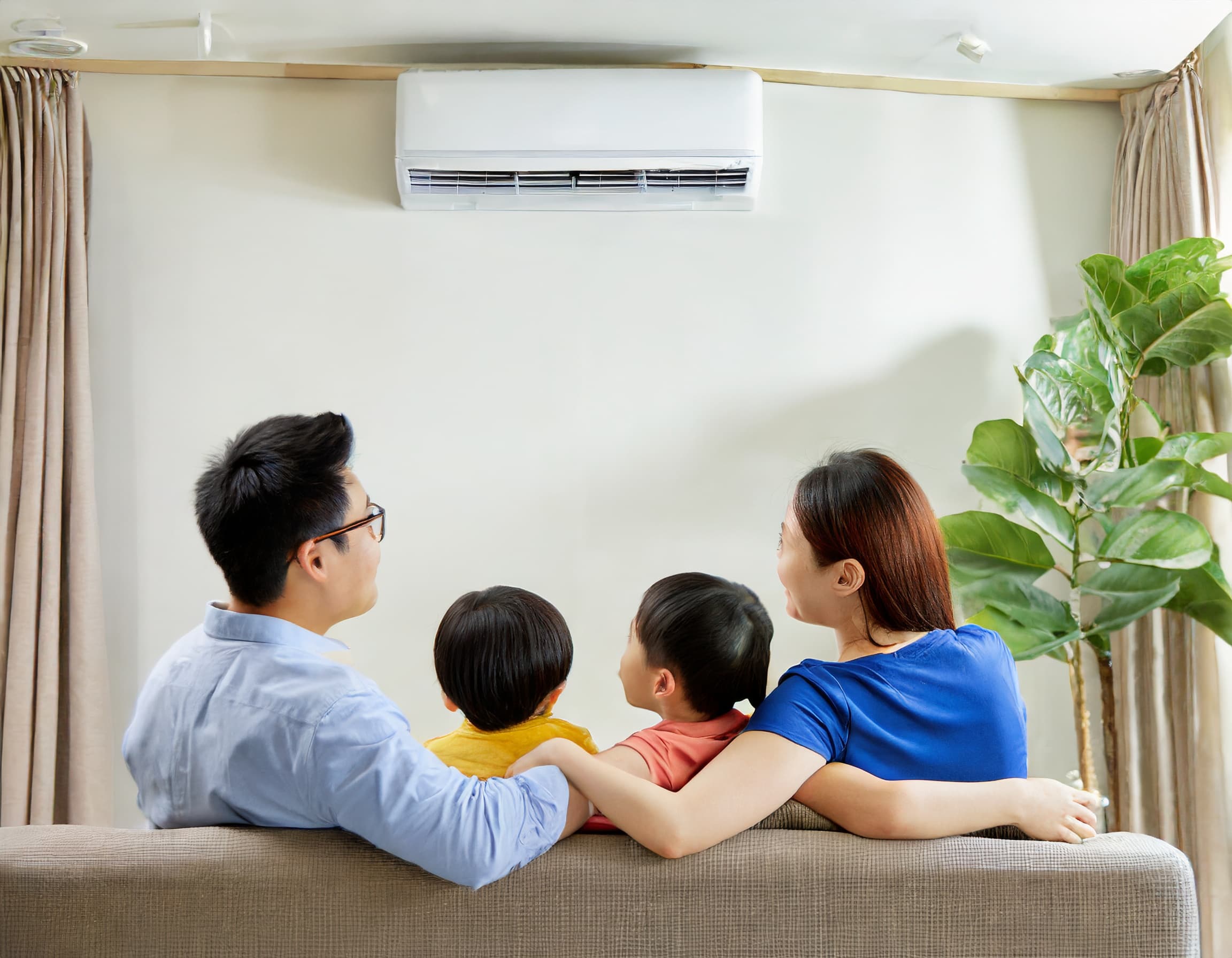 family enjoying cool air from aircon