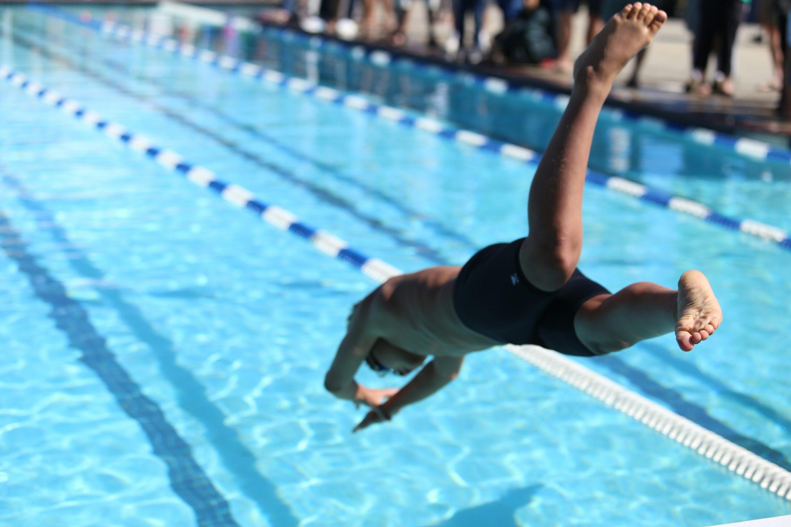 image of swimmer diving into a swimming pool