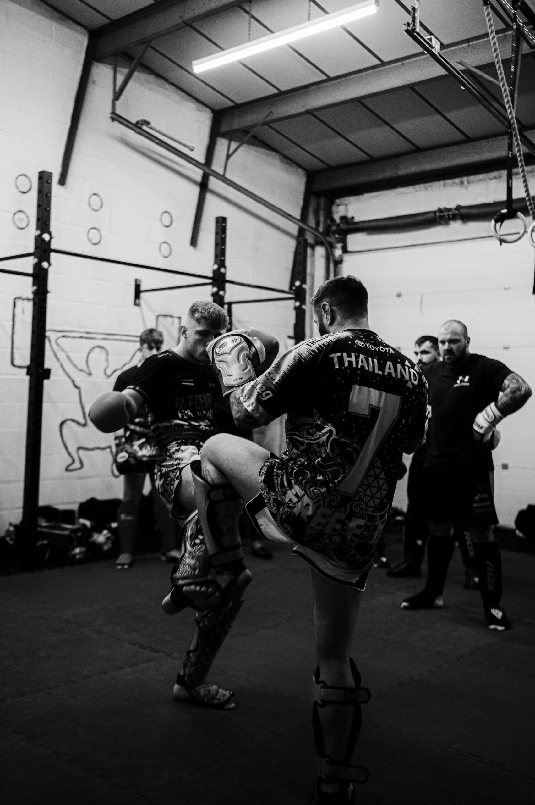 two guys sparring in a kickboxing gym