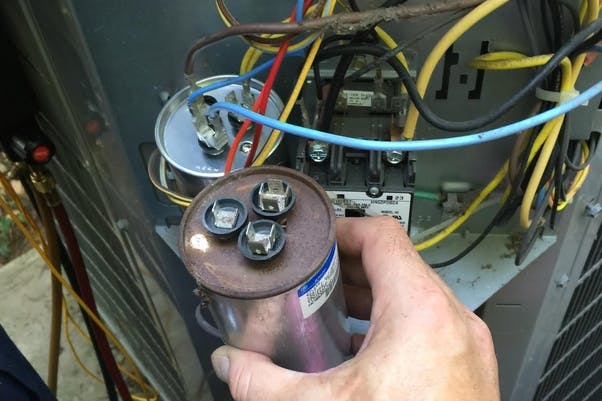 https://blogs.stringssg.com/wp-content/uploads/2023/08/aircon-capacitor-repair.jpg