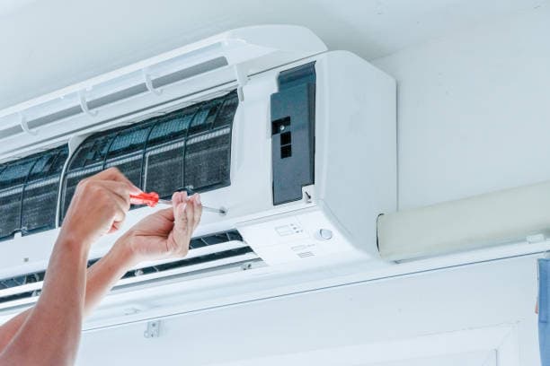 technician repairing the aircon unit